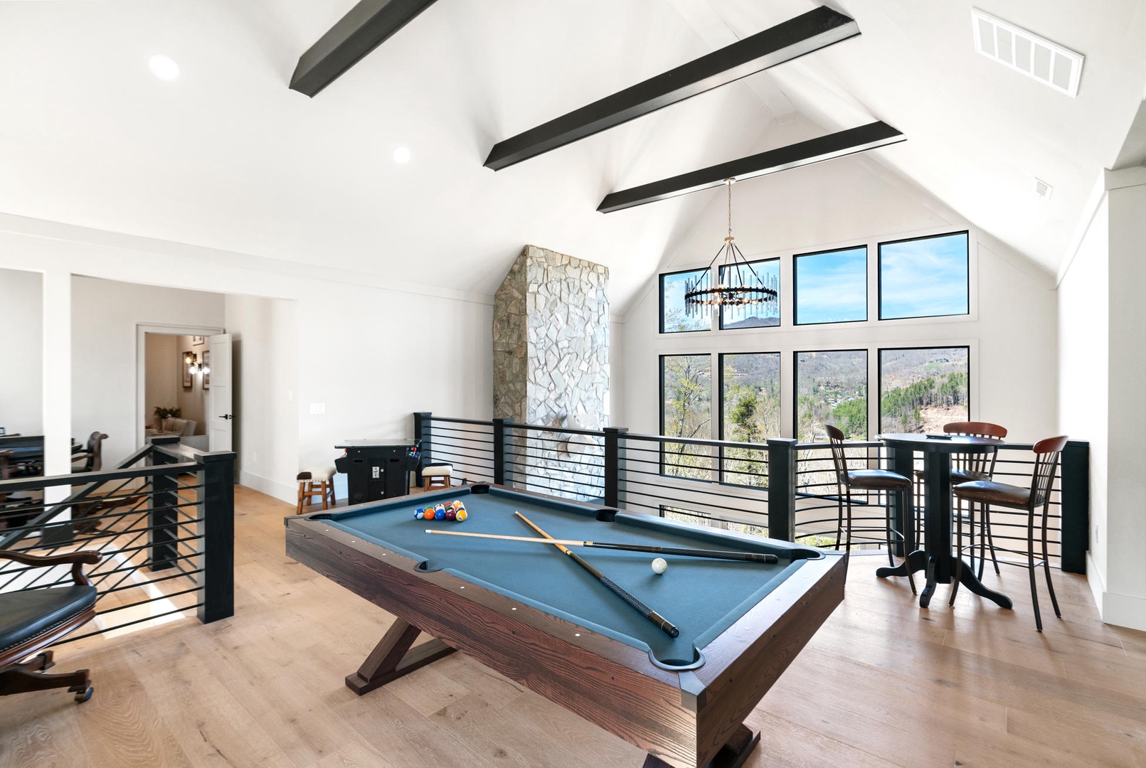 Challenge friends to pool games in your bright loft space with soaring ceilings, exposed beams, and mountain views through expansive windows.