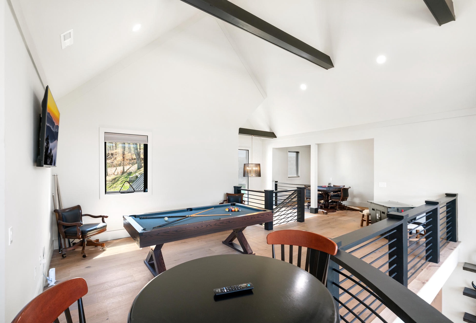 Unwind in your spacious game room with pool table, flat-screen TV, and modern seating perfect for evening entertainment.
