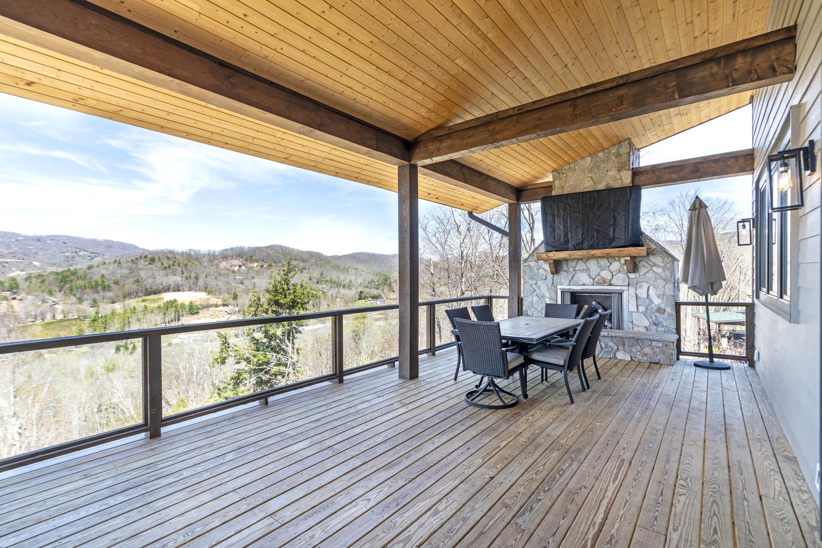 Relax on your private covered deck with stunning mountain views, cozy fireplace, and outdoor dining space perfect for morning coffee or evening gatherings.
