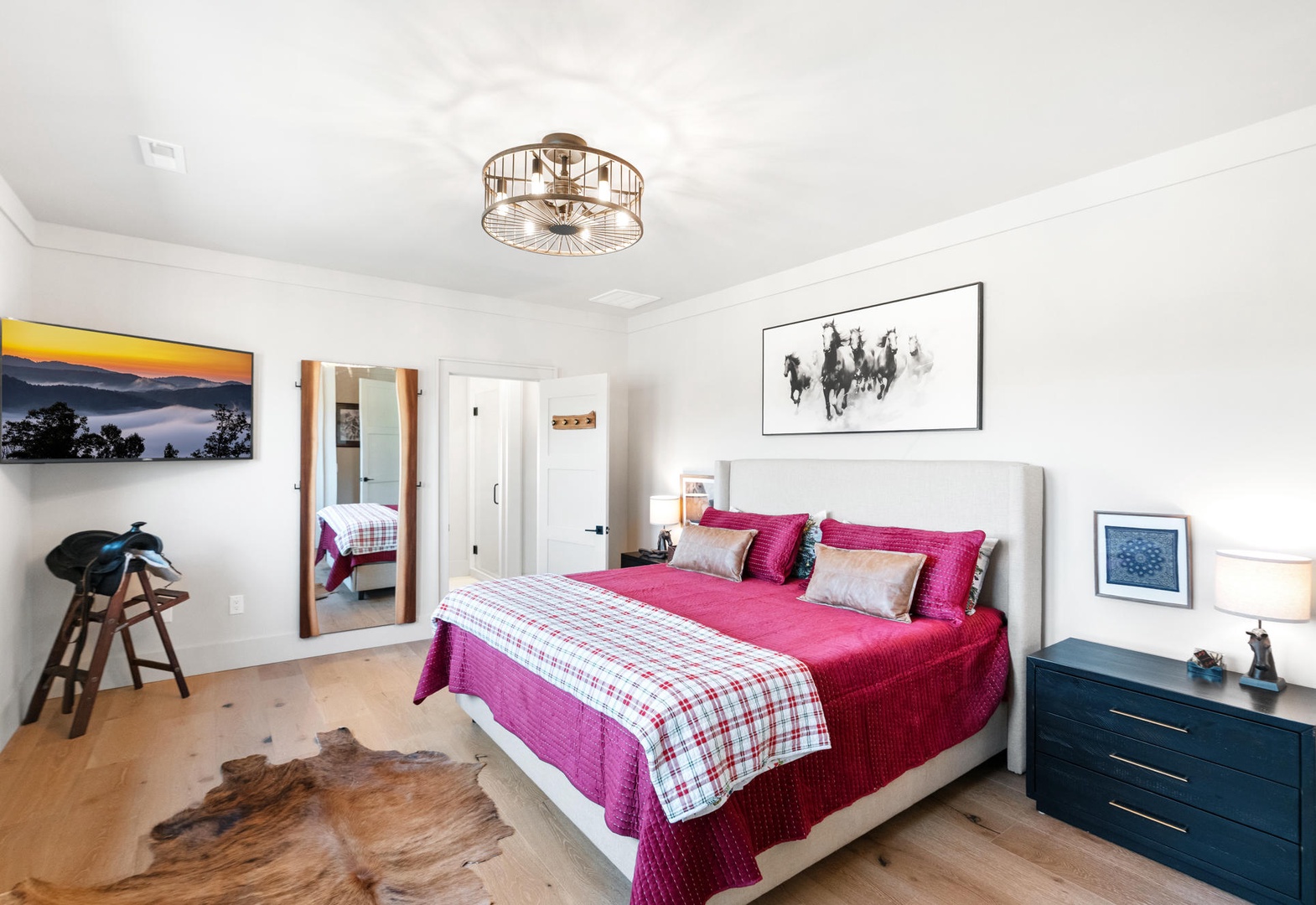 Rest peacefully in your stylish bedroom featuring vibrant bedding, elegant lighting, and thoughtful artwork creating a welcoming retreat. King size bed, upstairs.