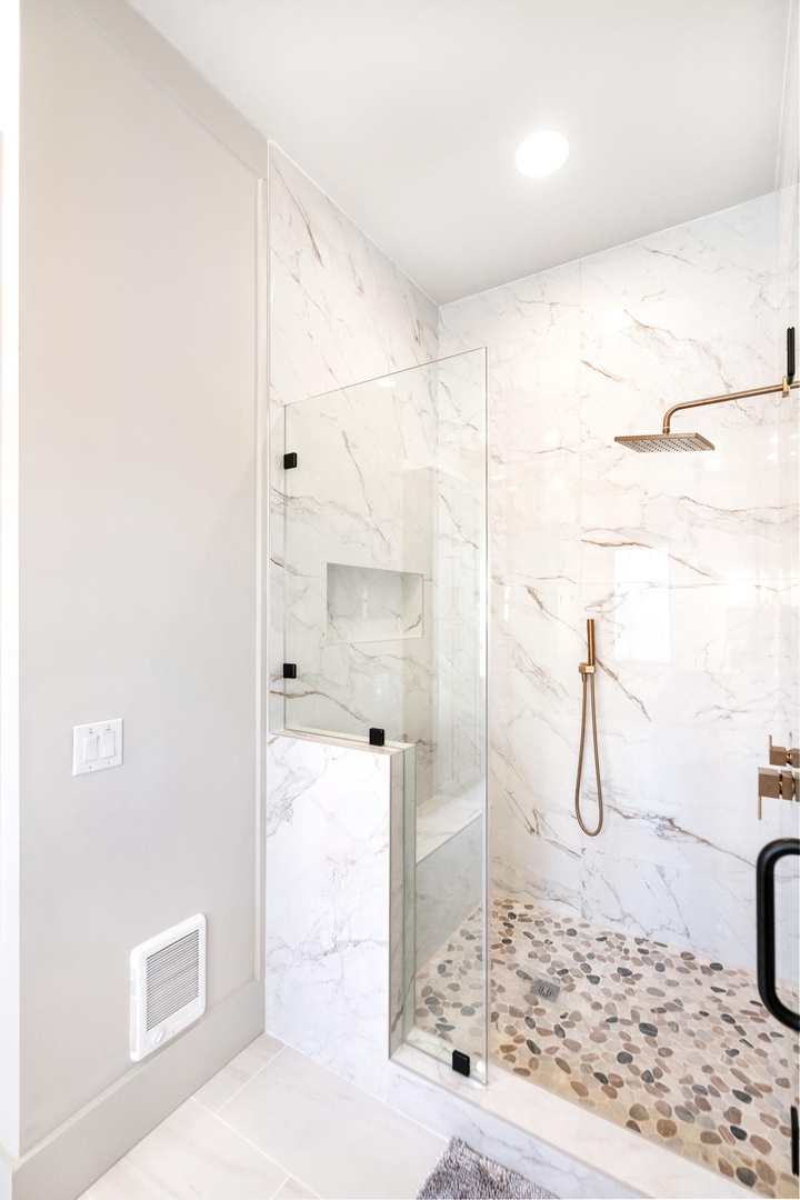 Step into your spa-like glass shower with luxurious marble walls and rainfall head for the ultimate refreshing experience.