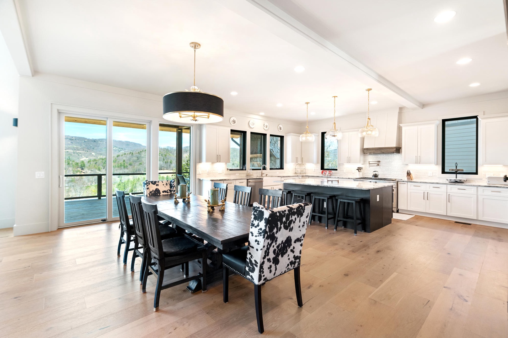 You'll love cooking and dining in this stunning open-concept space with mountain views, modern appliances, and elegant lighting perfect for memorable meals.
