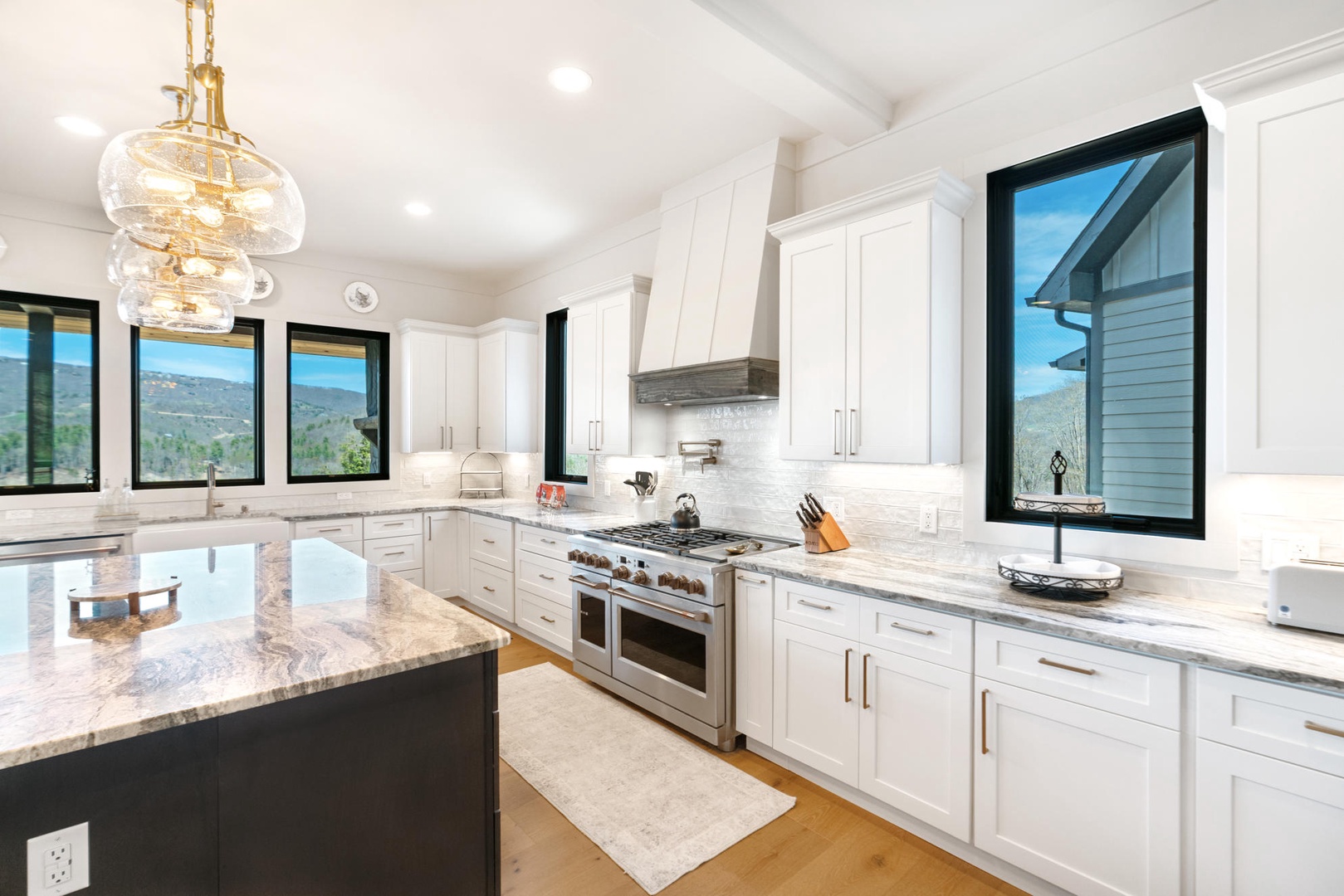 Your gourmet kitchen awaits with gleaming granite countertops, professional-grade appliances, and stunning mountain views through every window.