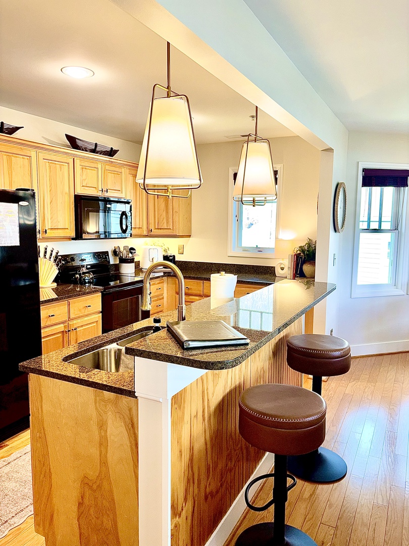 Fully equipped kitchen with everything you need, plus bar seating for easy meals.