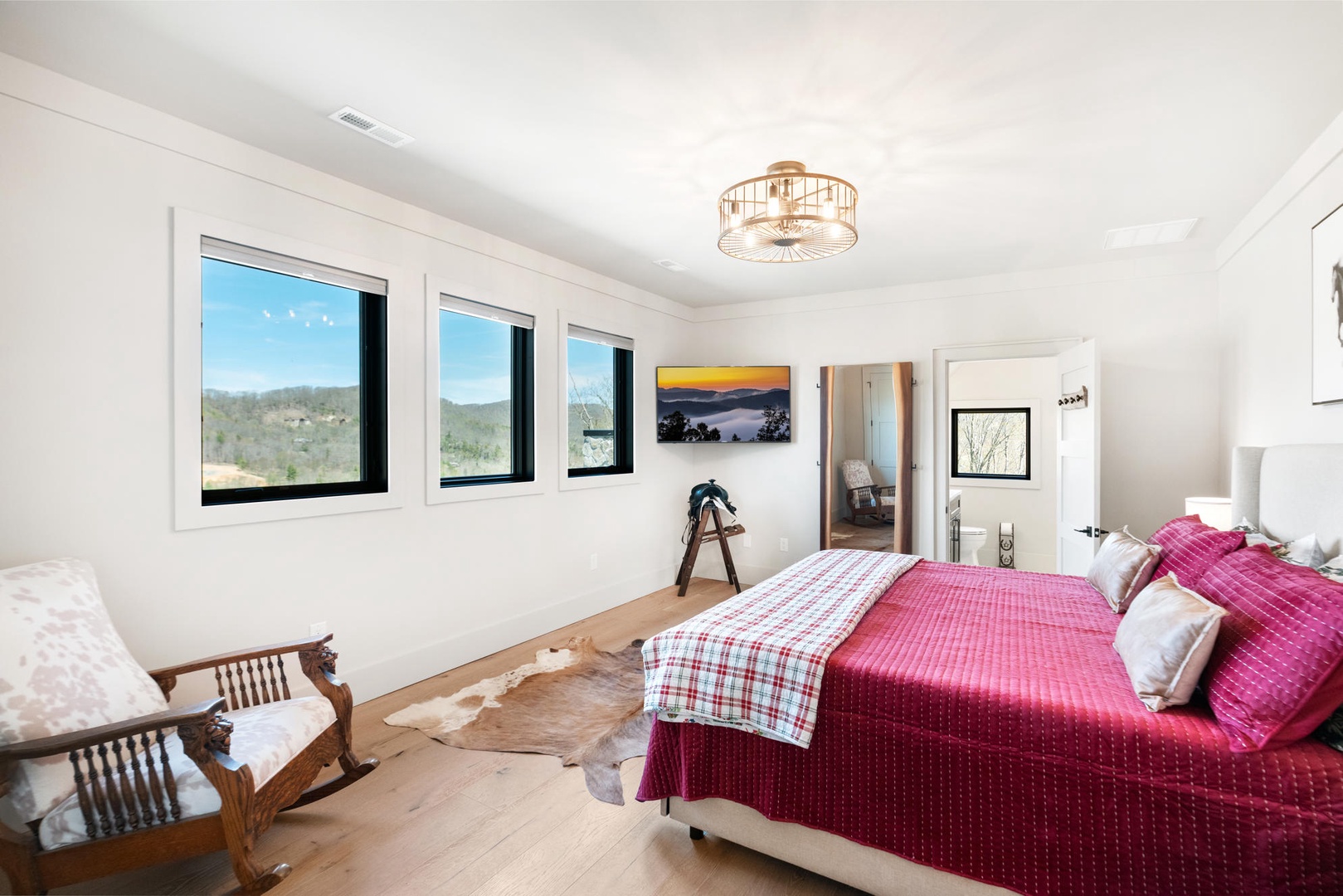 Drift off peacefully in your elegant bedroom with stunning mountain views, plush bedding, and warm natural lighting. King size bed, upstairs.