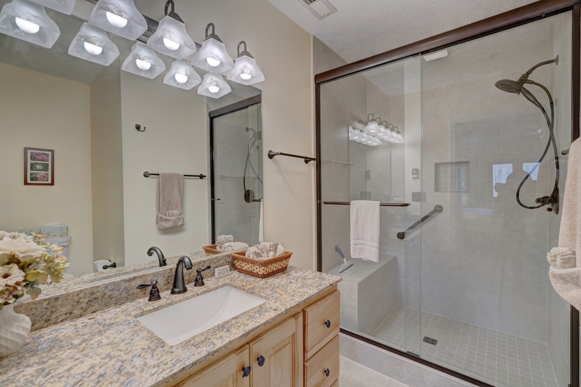 Primary Bathroom---Granite Countertop, Tile Shower