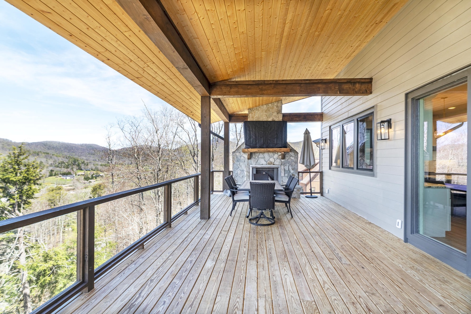 Your private deck awaits with stunning mountain views, cozy fireplace seating, and peaceful surroundings for morning coffee or evening relaxation.