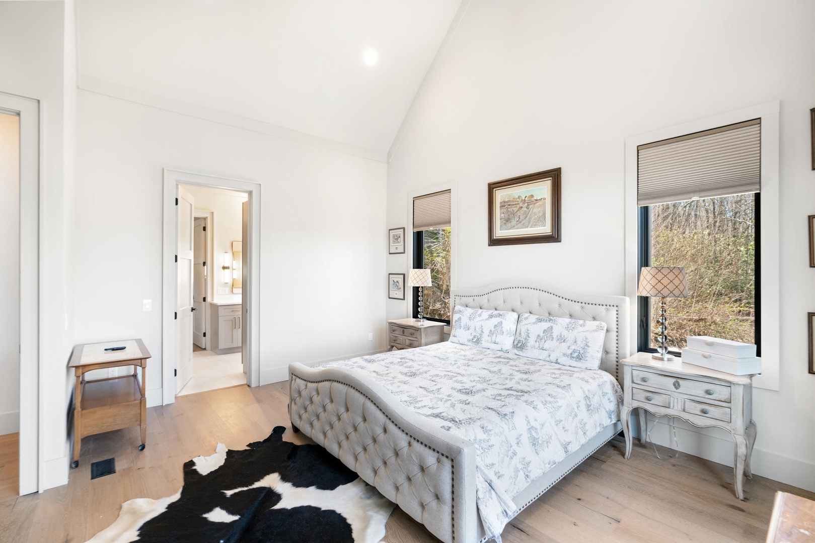 Rest easy in your elegant bedroom with vaulted ceilings, luxury linens, and peaceful garden views through oversized windows. King size bed, main floor.