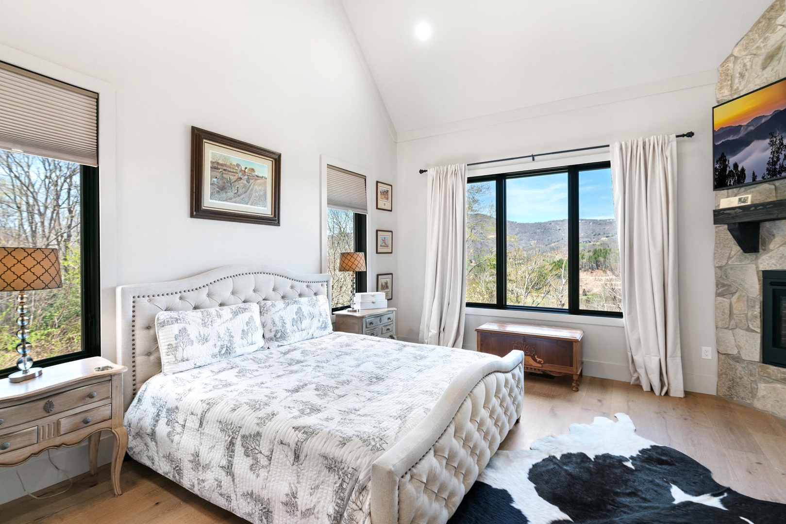 Drift into peaceful slumber in your elegant retreat, where plush bedding meets stunning mountain views through expansive windows. King size bed, main floor.