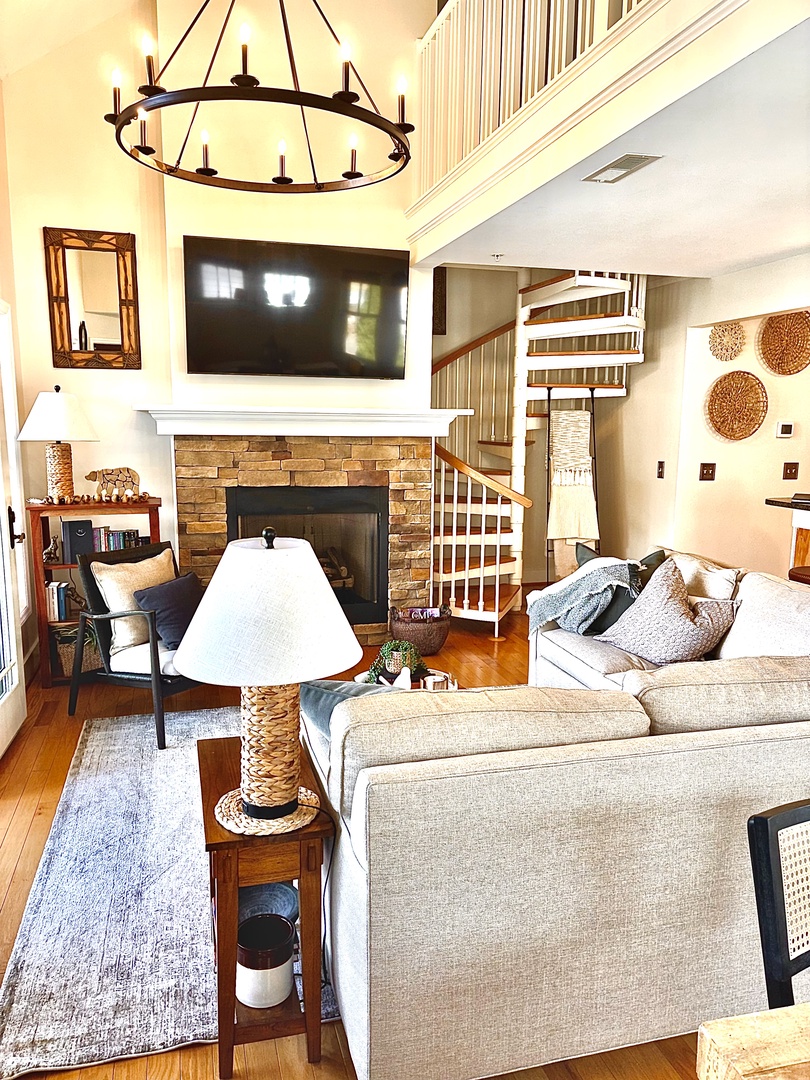 Warm, inviting living space with fireplace and mountain views just beyond.