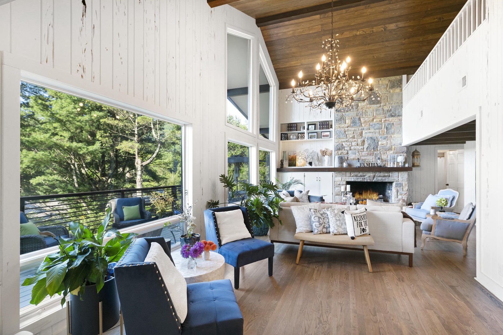 Living Room---Ample Seating, Soaring Ceilings, Fireplace, Natural Lighting.