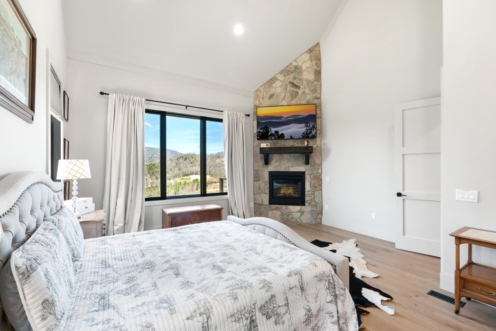 Drift into peaceful sleep in your elegant suite, where a cozy fireplace and panoramic mountain views create the perfect retreat.