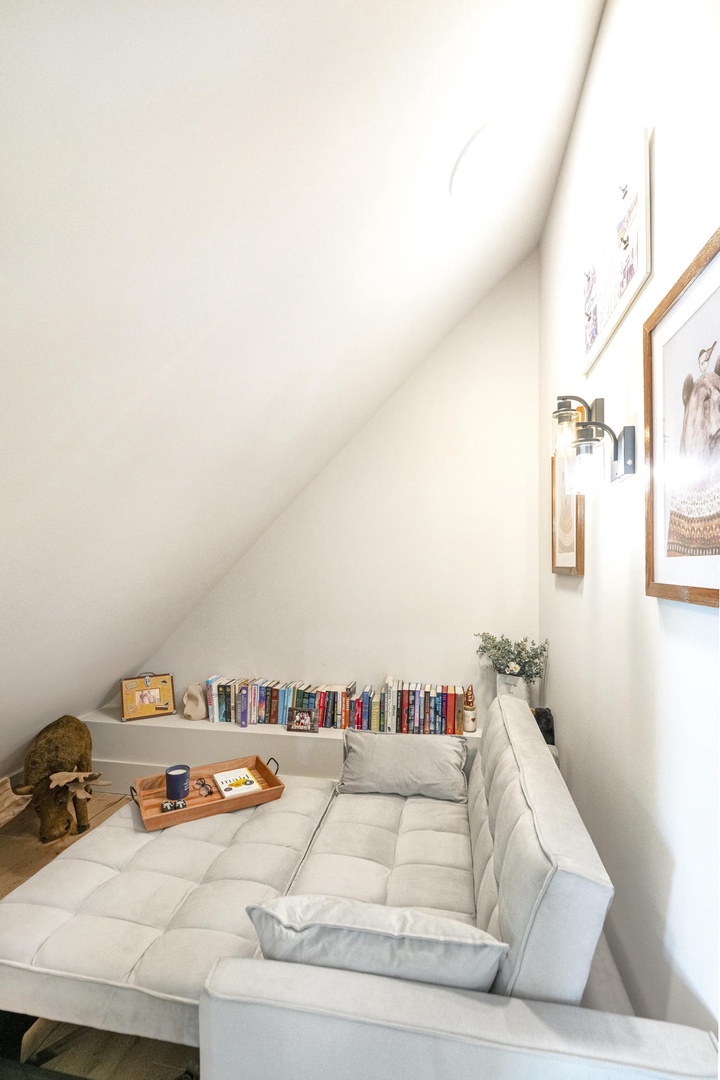 Curl up in your cozy reading nook with soft cushions, curated books, and warm natural light streaming in.