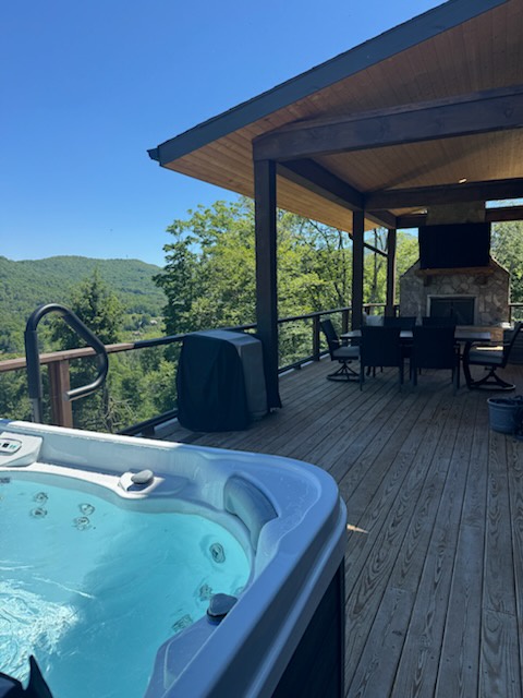 Unwind in your private hot tub while soaking in breathtaking mountain vistas, then gather around the outdoor fireplace for memorable evenings under the covered patio.