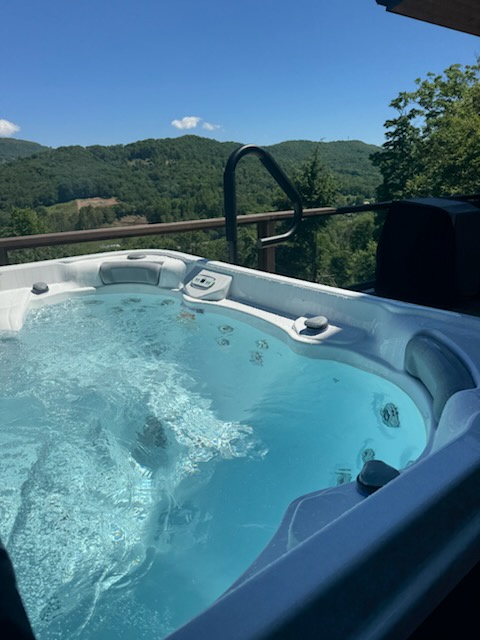 Immerse yourself in the bubbling hot tub while soaking in sweeping mountain vistas—your perfect escape to unwind under the open sky.
