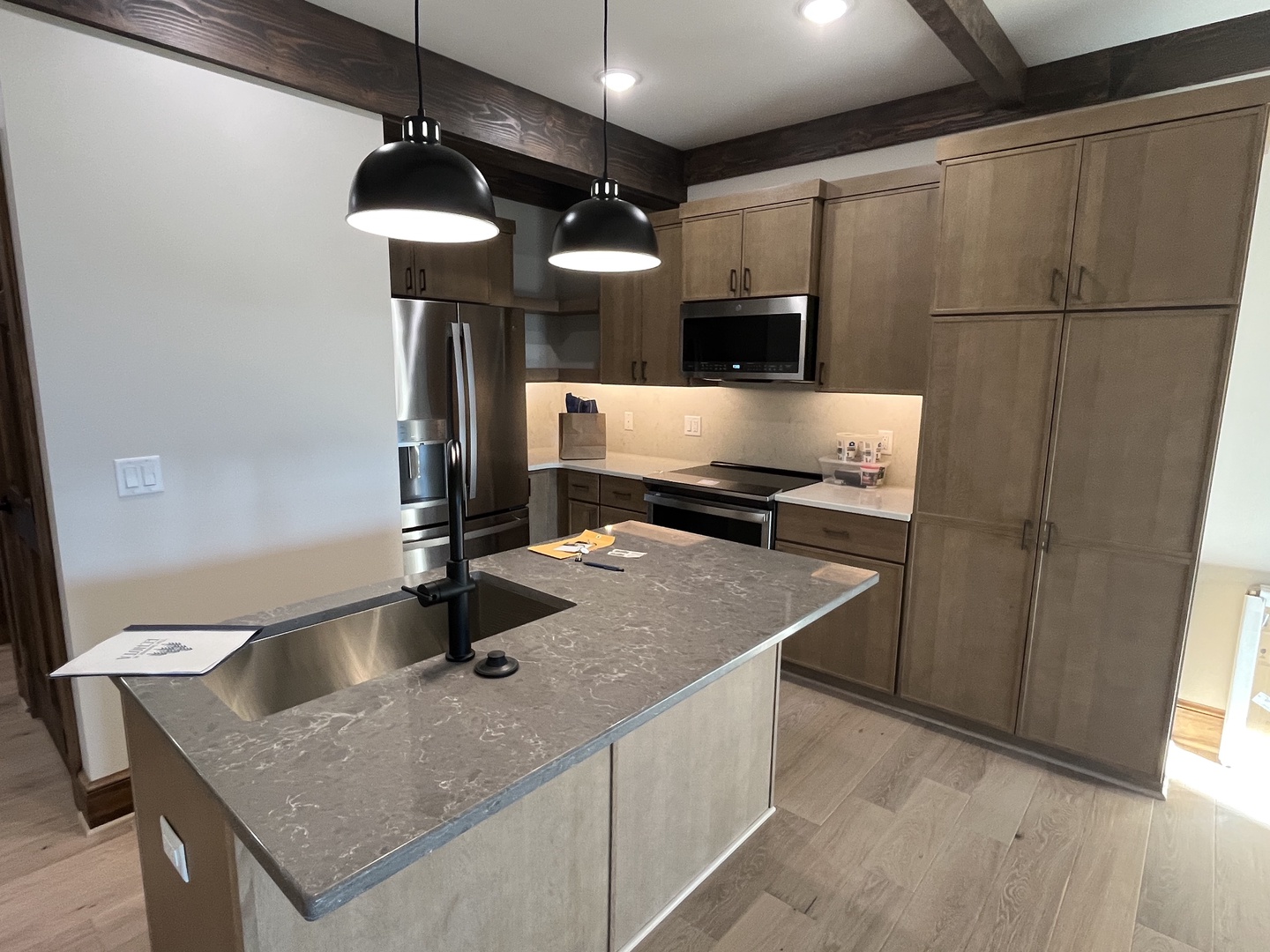 Your beautifully appointed kitchen features sleek pendant lighting, modern stainless steel appliances, and plenty of counter space for preparing meals during your stay.