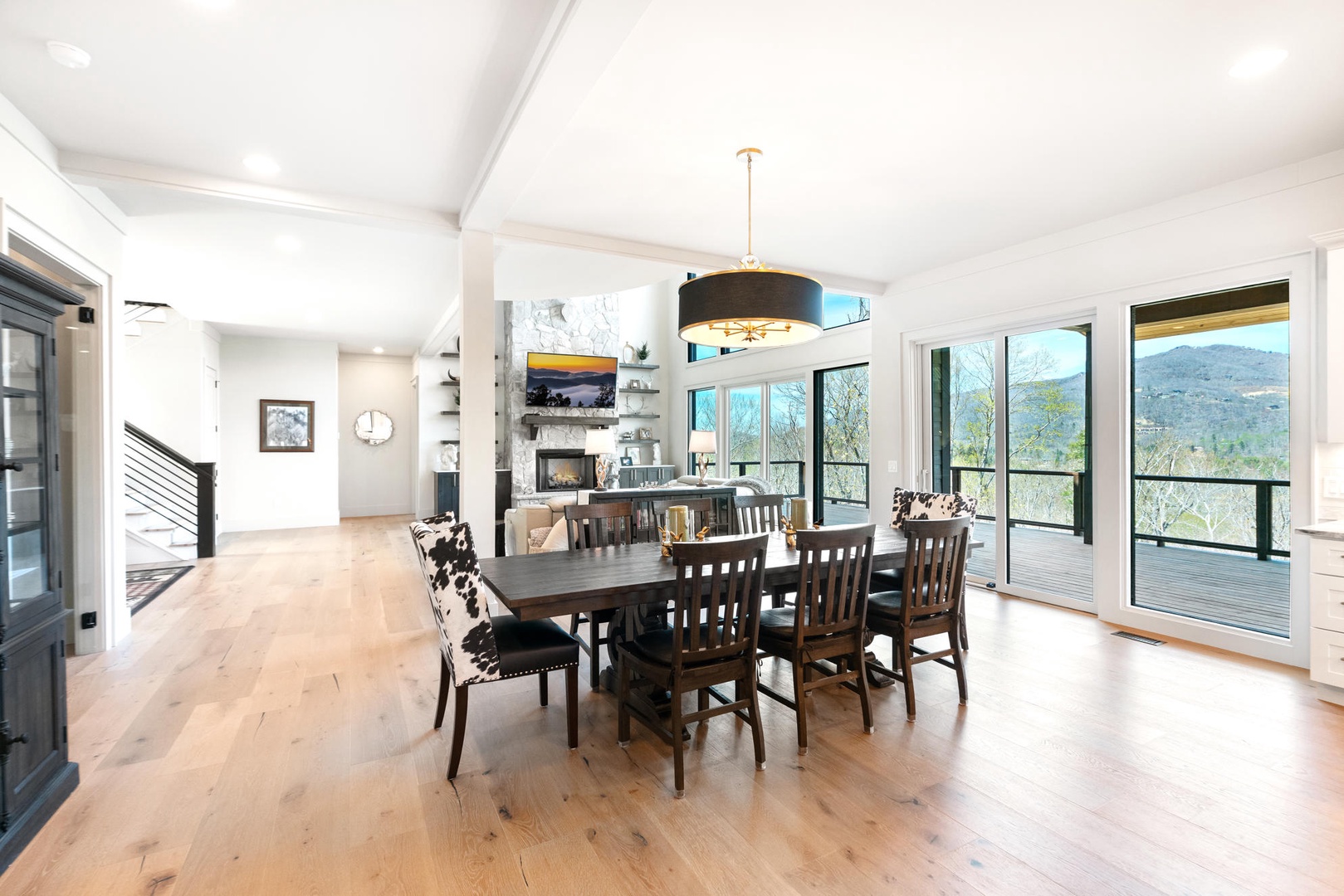 Gather around this stunning dining table where memorable meals await. Soaring ceilings and panoramic mountain views create the perfect backdrop for your getaway.