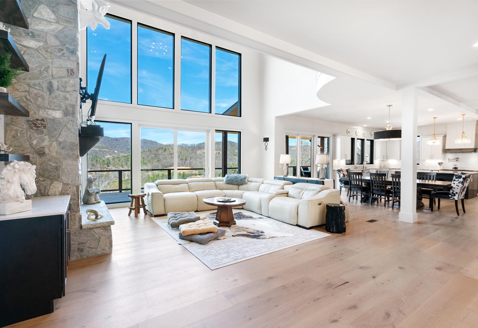 Sink into plush sofas and soak up stunning mountain views through soaring windows in your bright, open living space.