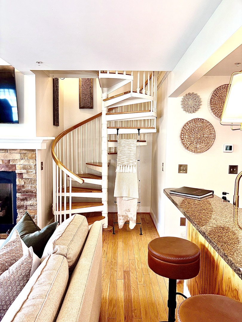 Warm, inviting living space with fireplace and mountain views just beyond.