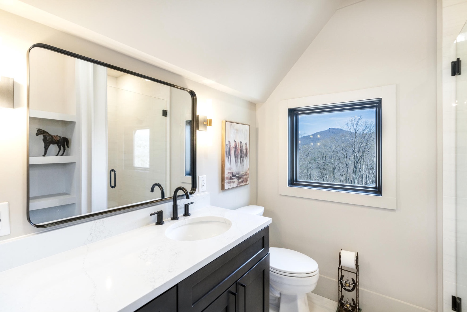 Refresh in your modern bathroom while enjoying stunning mountain views through the window.