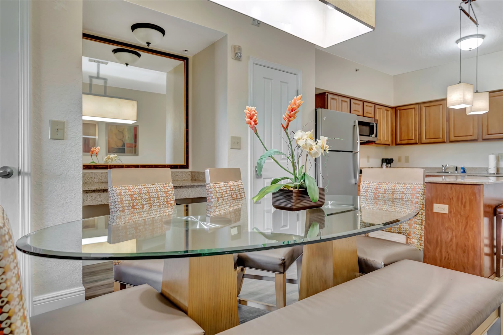 Gather around the inviting glass dining table that seats your whole group comfortably. Natural light pours through the skylight as you enjoy your morning coffee and plan the day's adventures together.
