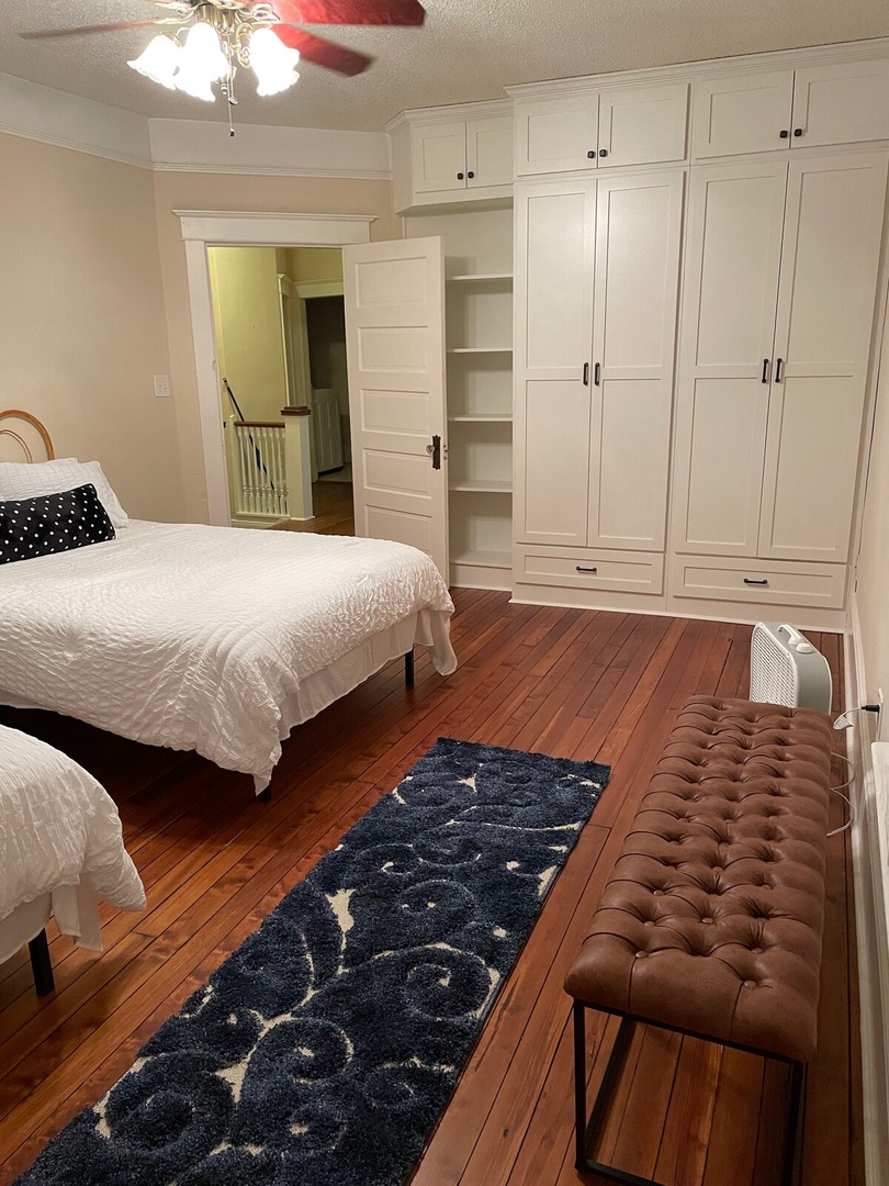 Your restful retreat features warm hardwood floors, abundant storage with built-in wardrobes, and a comfortable sleeping space—everything you need to settle in and unwind after a day of exploring.