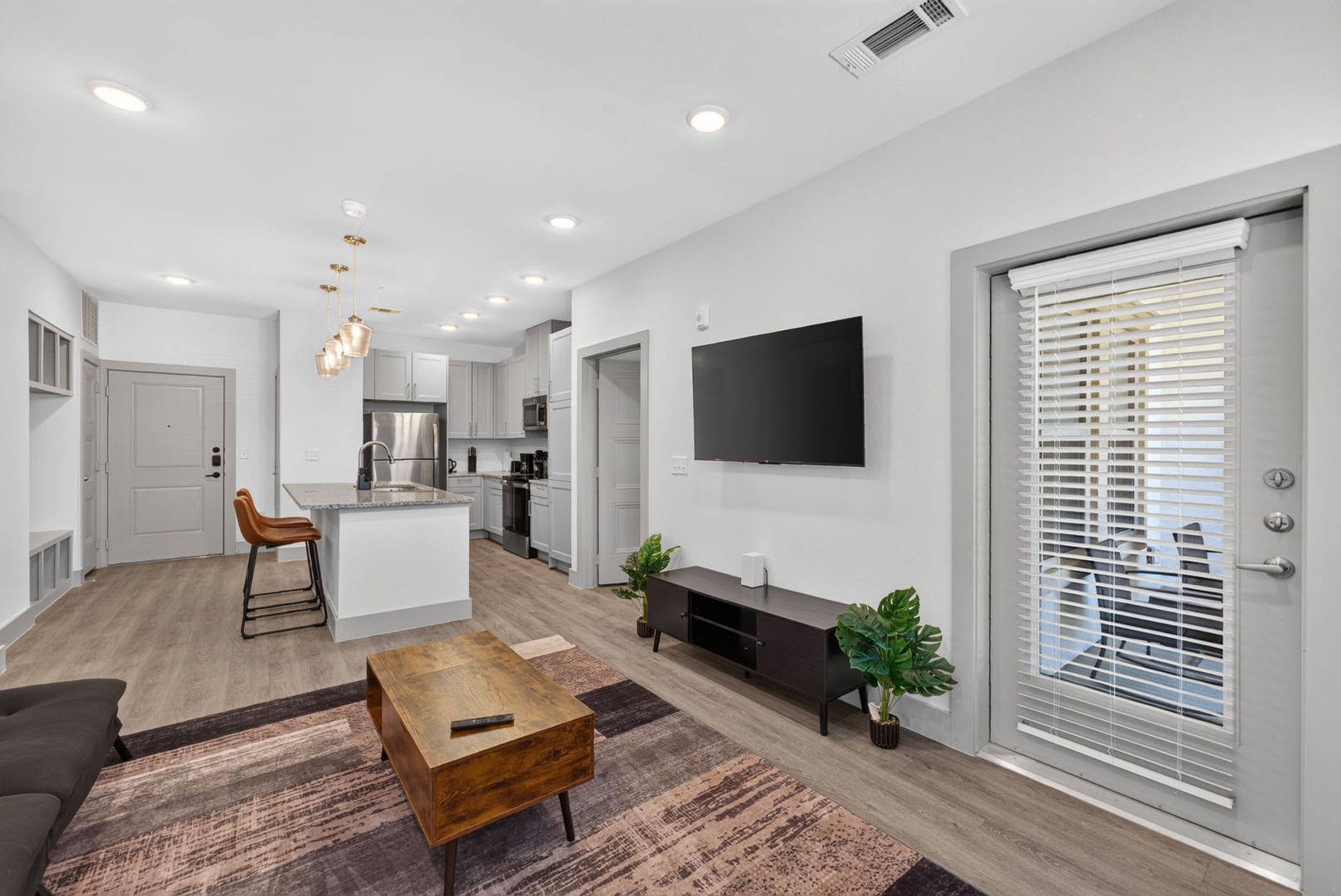 Step into your bright, modern open-concept space where sleek style meets comfort. The fully equipped kitchen flows seamlessly into your cozy living area—perfect for relaxing after exploring the area.