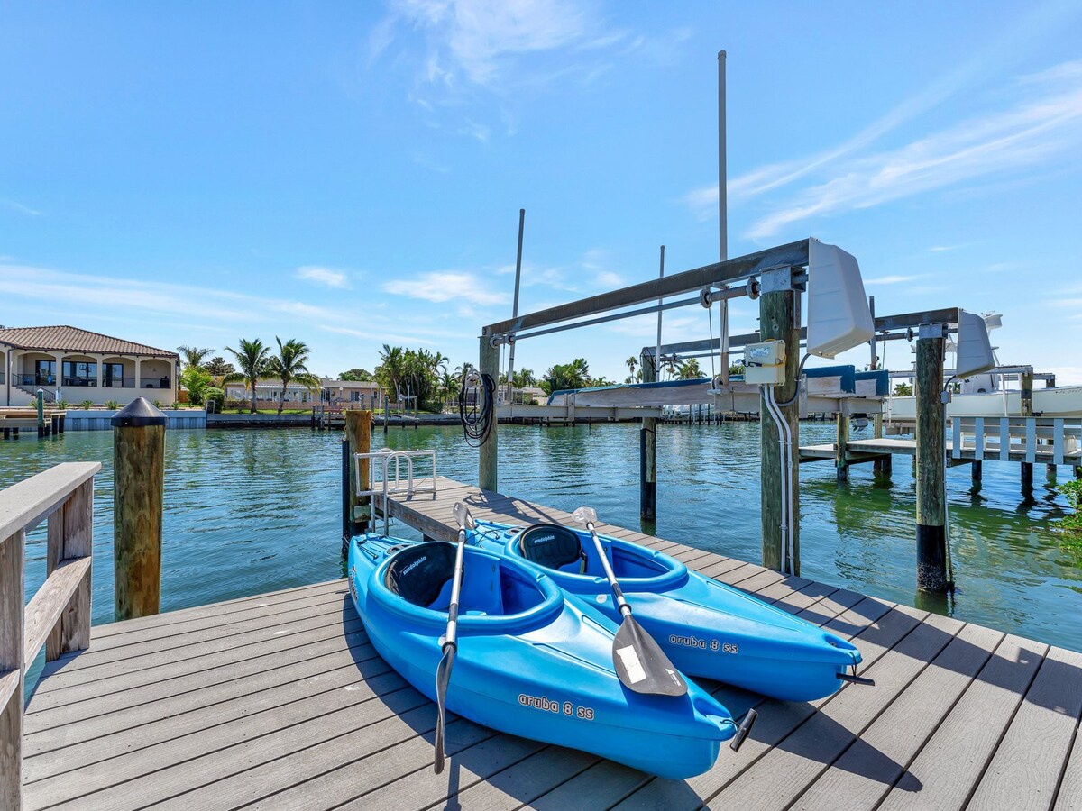 Two vibrant blue kayaks rest on your private dock, ready for adventure. Glide across calm canal waters, explore the waterfront neighborhood, and soak in the tropical surroundings at your leisure.