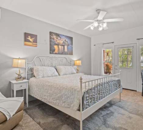 Unwind in your serene bedroom retreat, complete with plush bedding, soft lighting, and French doors opening to your private outdoor space.