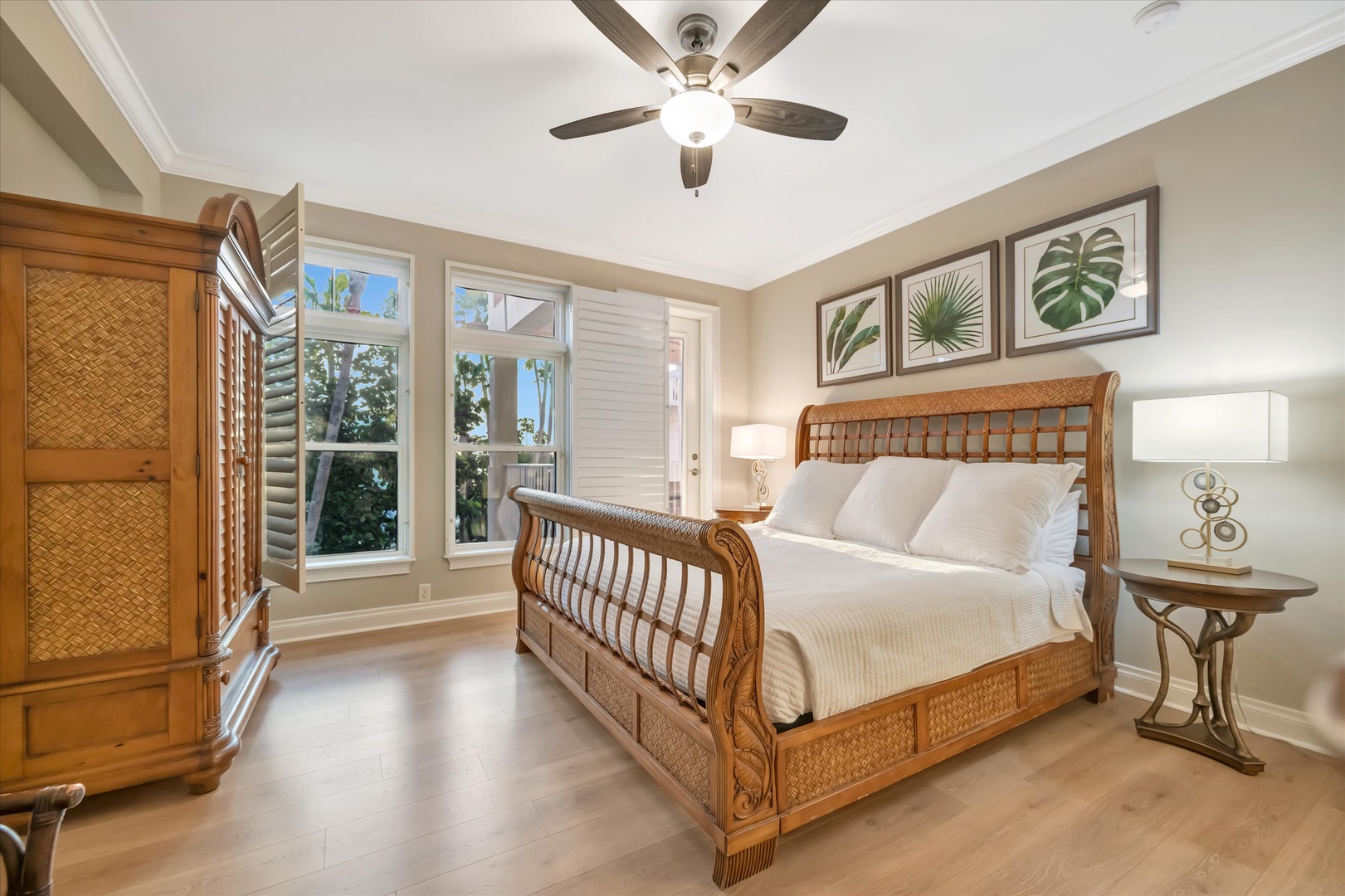 Relax in your tropical-inspired bedroom with handcrafted rattan furnishings and fresh linens. Natural light pours through plantation shutters while the ceiling fan keeps you cool.