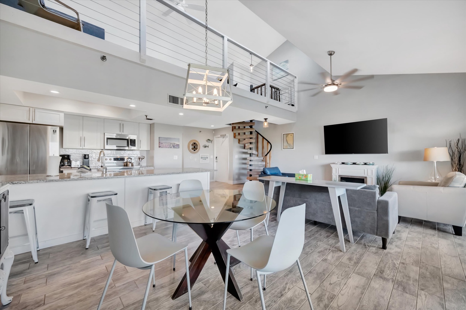 Step into your bright, airy retreat where soaring ceilings and modern coastal style create an effortless escape. The open layout invites you to unwind with your group, cook together in the full kitchen, and relax in tasteful comfort.