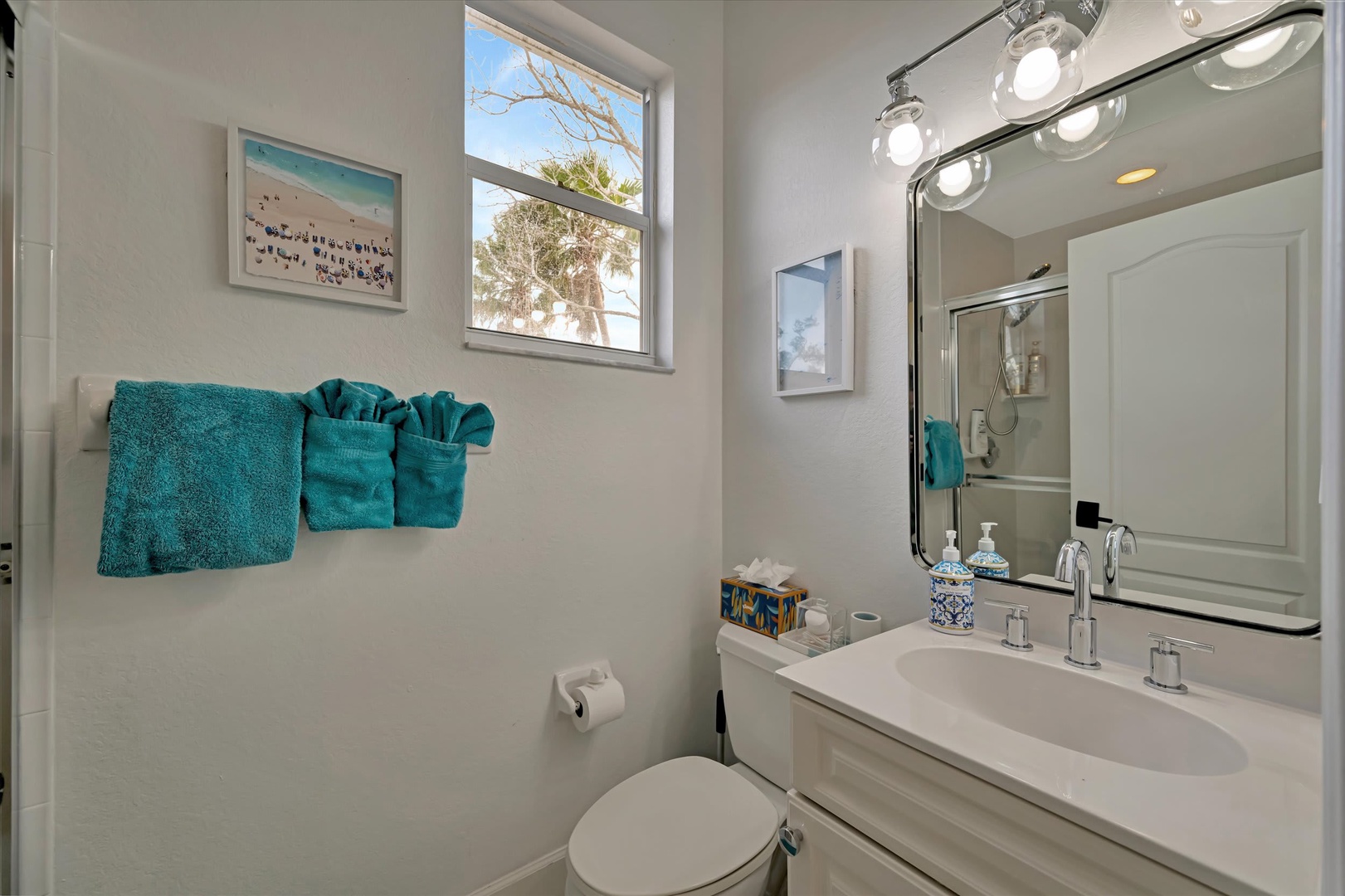 Freshen up in your bright, spotless bathroom with plush towels and coastal charm. Natural light streams through the window, making morning routines feel like a mini spa escape.