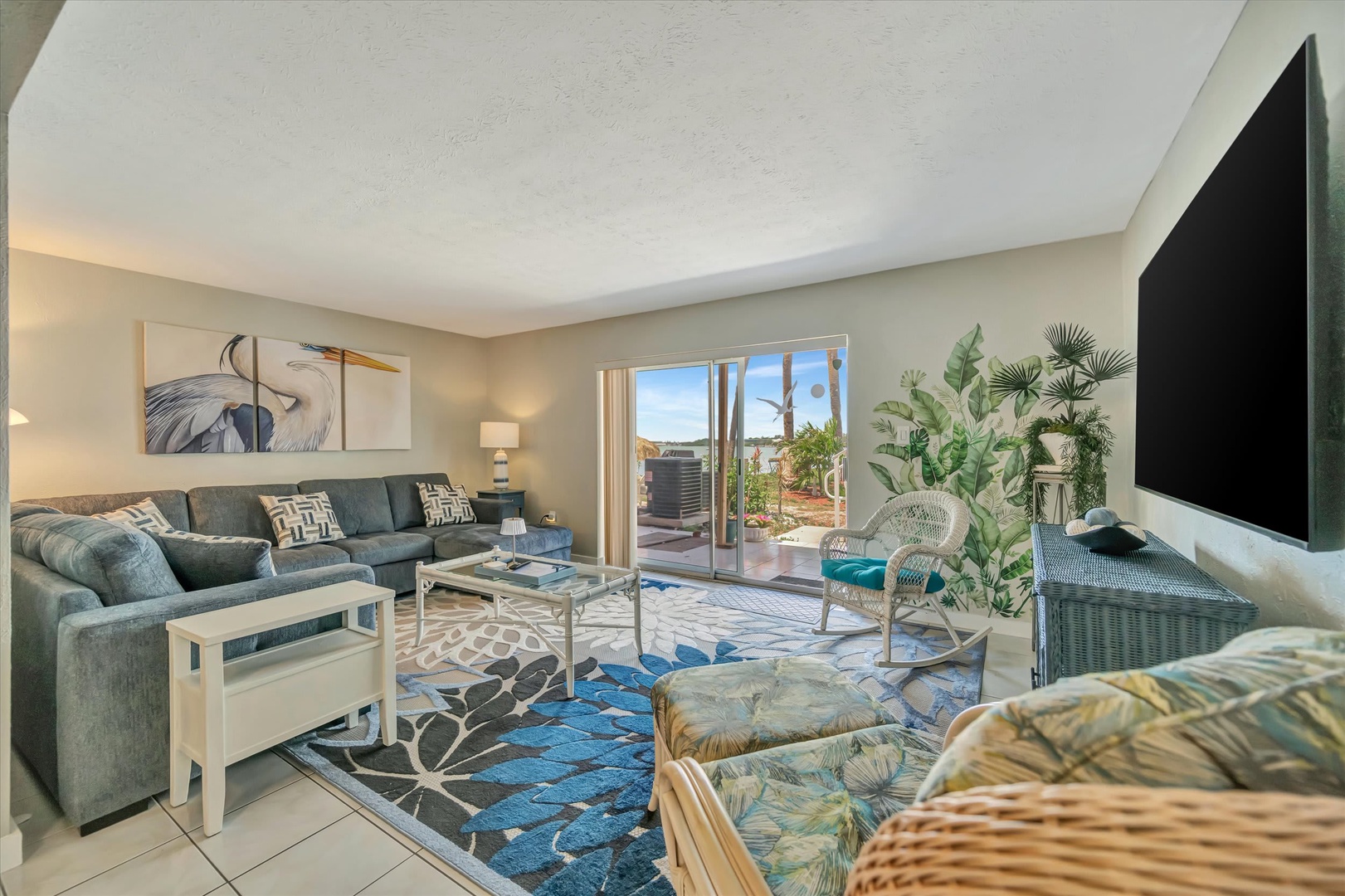 Settle into your inviting living space with plush seating and bright natural light streaming through sliding doors to your private patio. Coastal-inspired décor and plenty of room to relax make this the perfect spot to unwind.