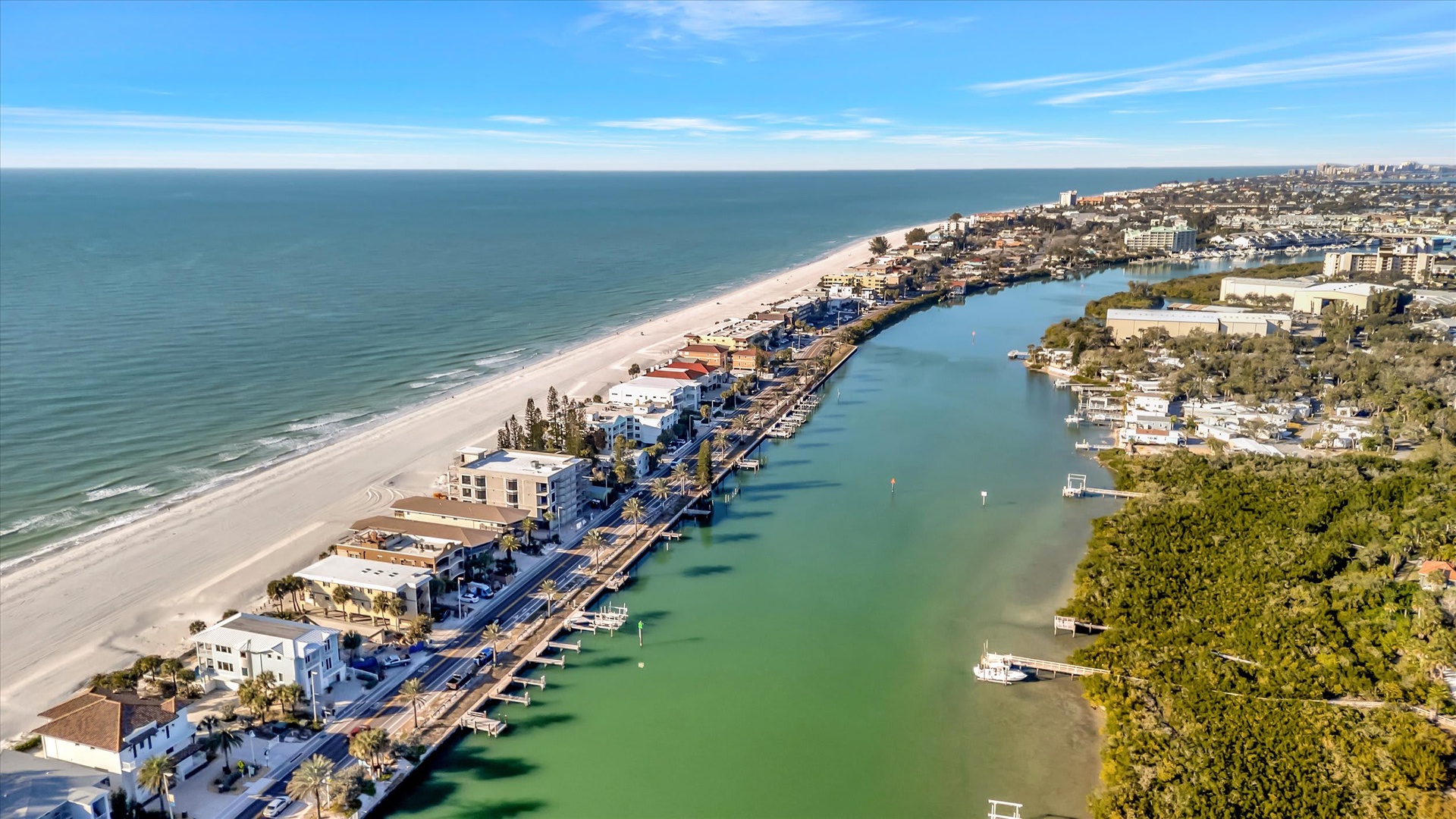 A stunning aerial view showcasing the beachfront community nestled between the Gulf of Mexico and the tranquil inland waterway, offering a picturesque coastal setting.