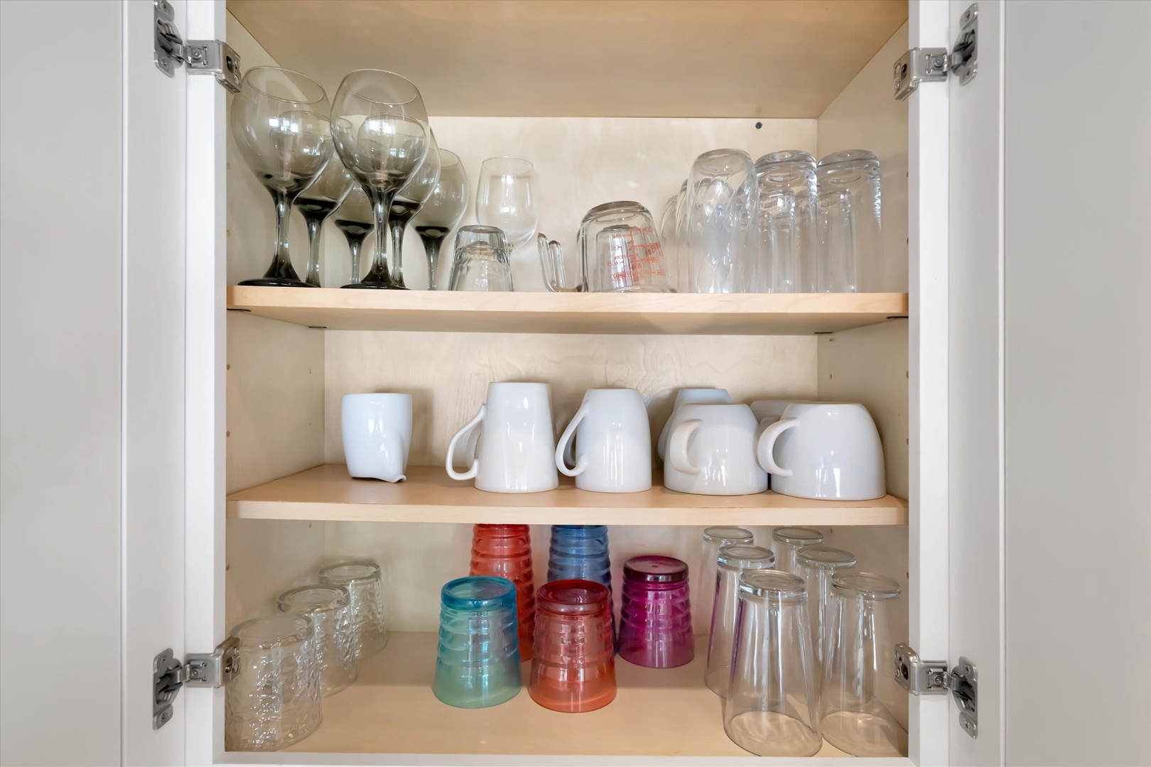 Everything you need is thoughtfully organized, from wine glasses to coffee mugs, making your mornings and evenings feel effortless and at home.