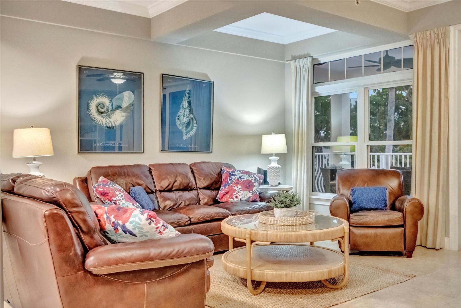 Sink into the plush leather seating and let natural light pour in through the skylight and French doors. Your peaceful retreat features coastal-inspired art and opens to a private balcony.