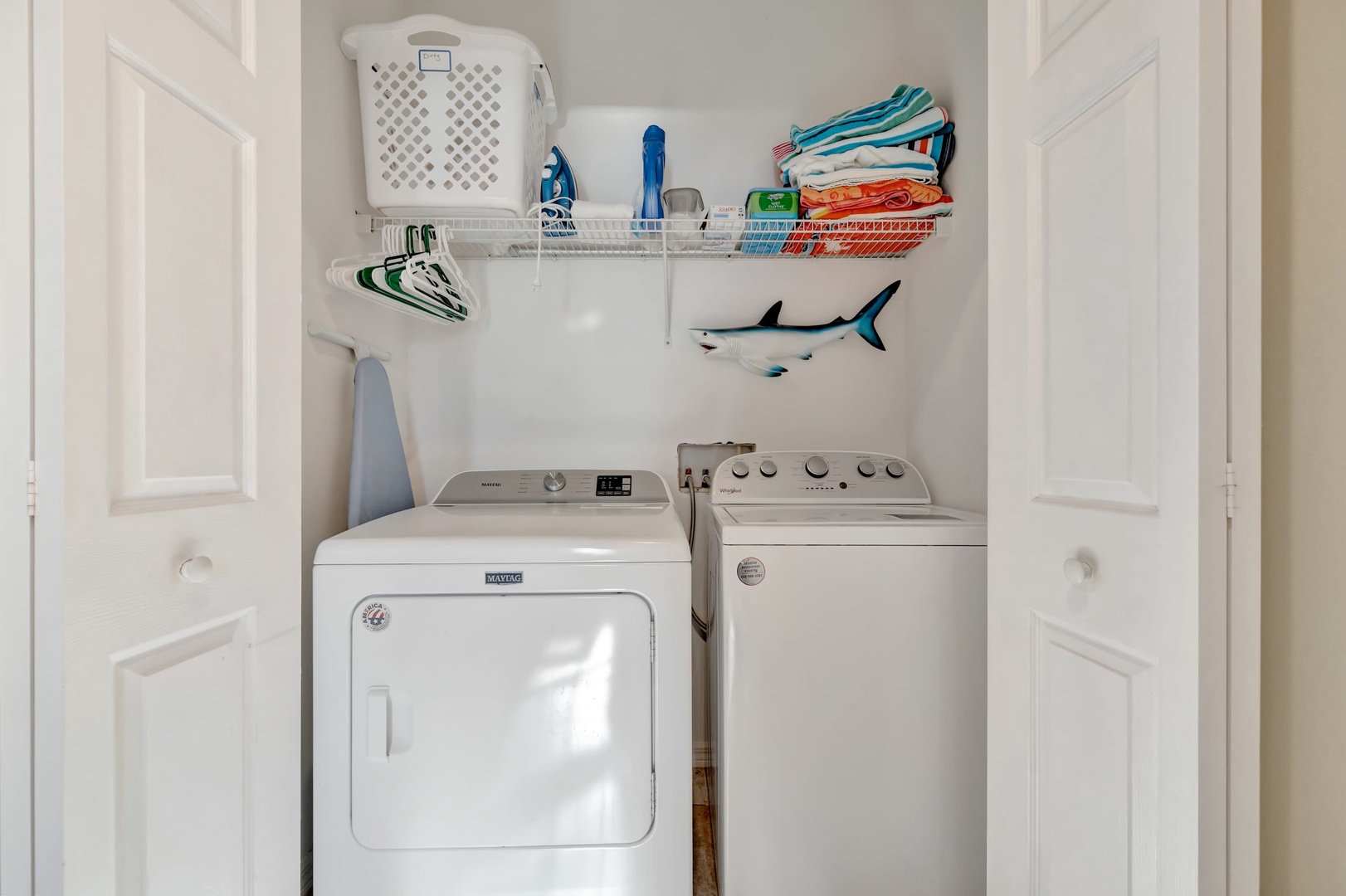 Handle laundry with ease in your private washing closet, complete with a full-size washer and dryer, plenty of storage shelves, and thoughtful touches like colorful beach towels ready for your next adventure.