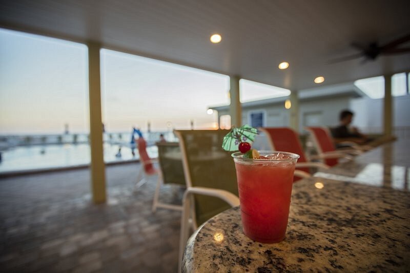 Sip your favorite tropical drink at the bar while taking in serene ocean views—the perfect spot to unwind after a day at the beach.