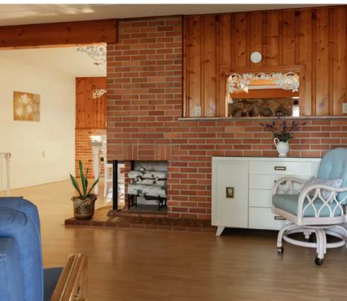 Step into your cozy living space, where rustic brick warmth meets modern comfort. The inviting fireplace creates the perfect spot to unwind after exploring nearby attractions.
