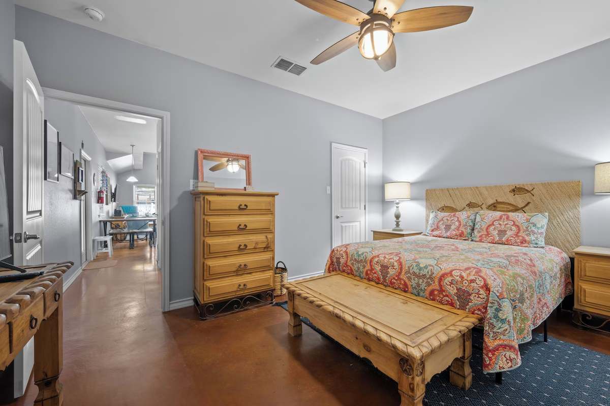 Your peaceful retreat awaits with coastal-inspired decor, warm wood accents, and a ceiling fan to keep you cool on warm evenings.