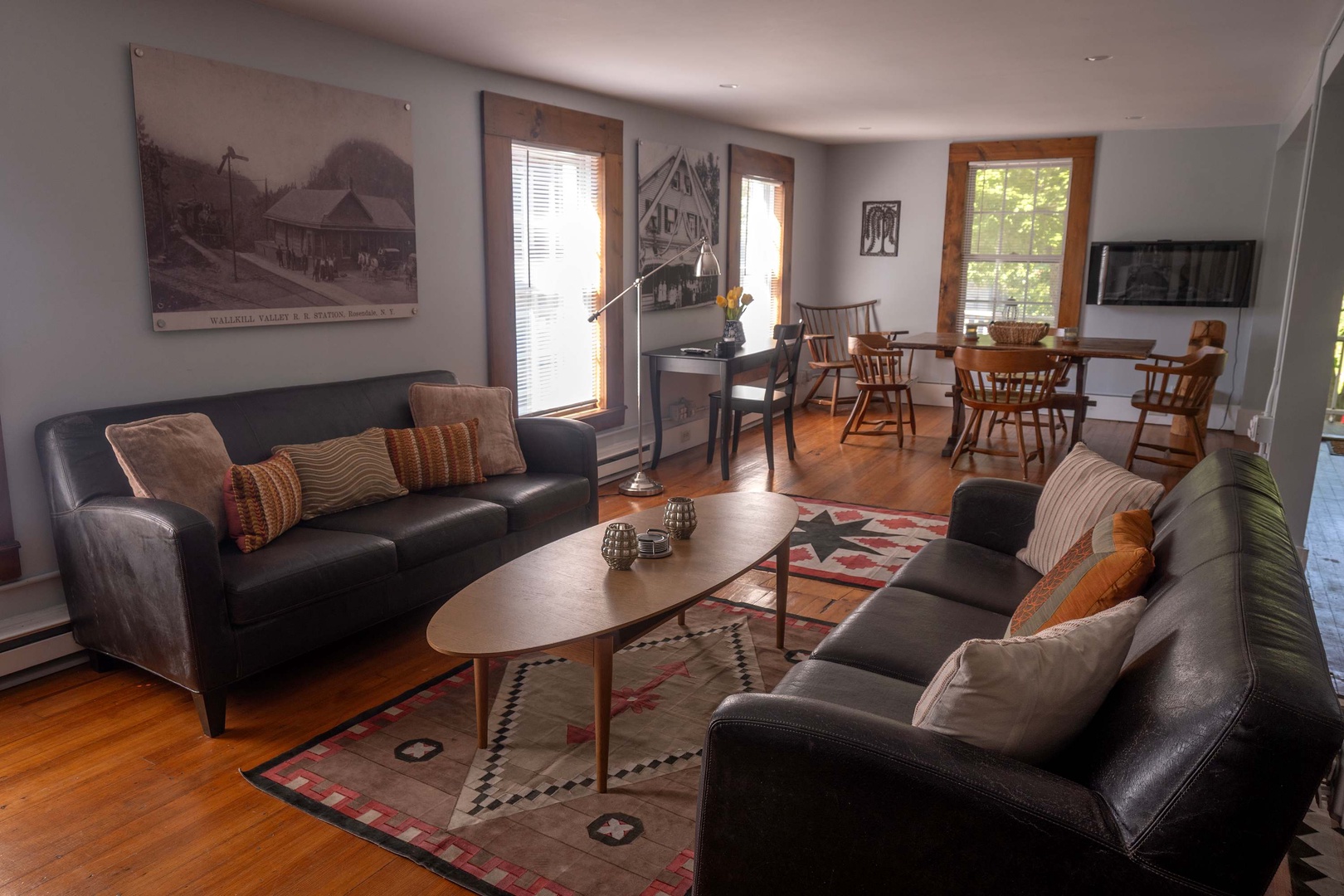 Sink into plush leather sofas and unwind in your open-concept retreat, where warm wood floors and natural light create an inviting space for gathering with loved ones.