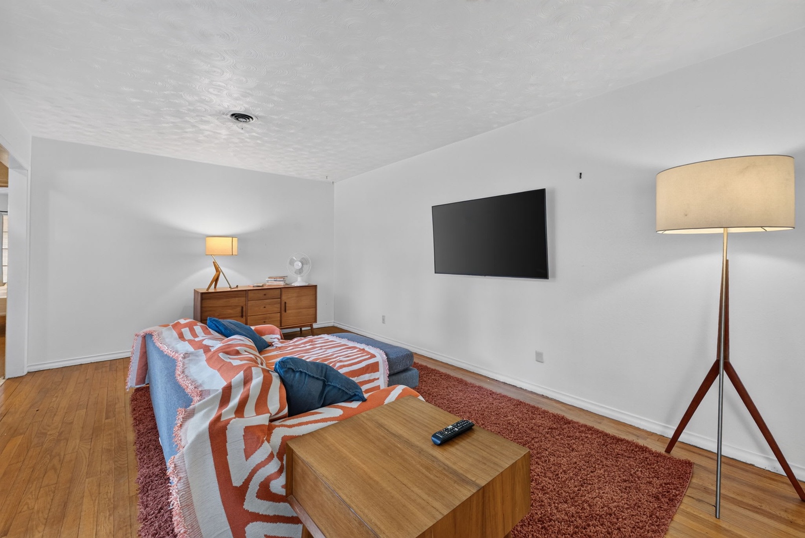 Unwind in your cozy lounge with a stylish mid-century vibe, soft lighting, and all the comforts you need for laid-back evenings.