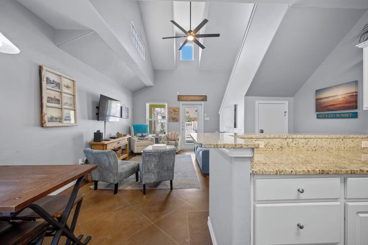 Step into this airy, open-concept retreat where vaulted ceilings and coastal touches create a light-filled haven for relaxation and gathering.