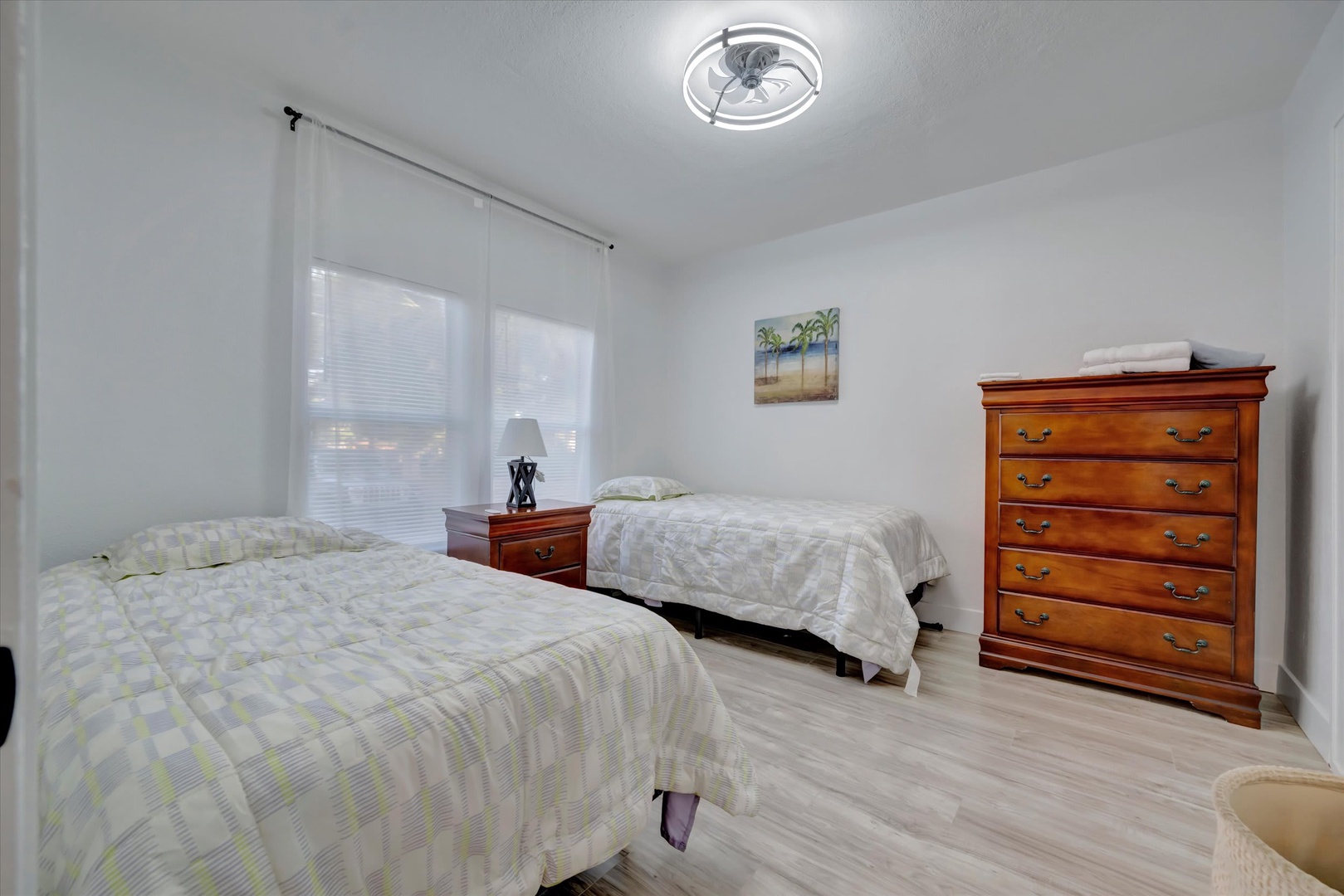 Unwind in your bright, spacious bedroom with two comfy beds and plenty of natural light streaming through large windows.