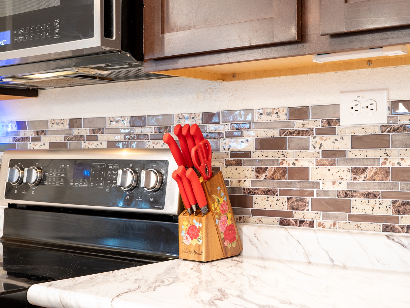 Your well-equipped kitchen features modern stainless appliances, elegant marble countertops, and a decorative tile backsplash—everything you need to prepare your favorite meals.