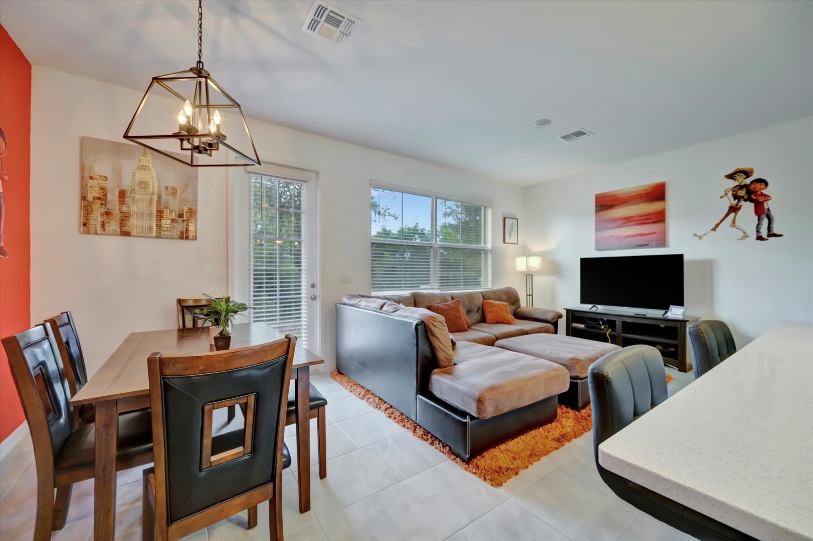 Settle into your spacious open-plan living area, where natural light streams through large windows and modern furnishings invite relaxation after a day exploring the area.