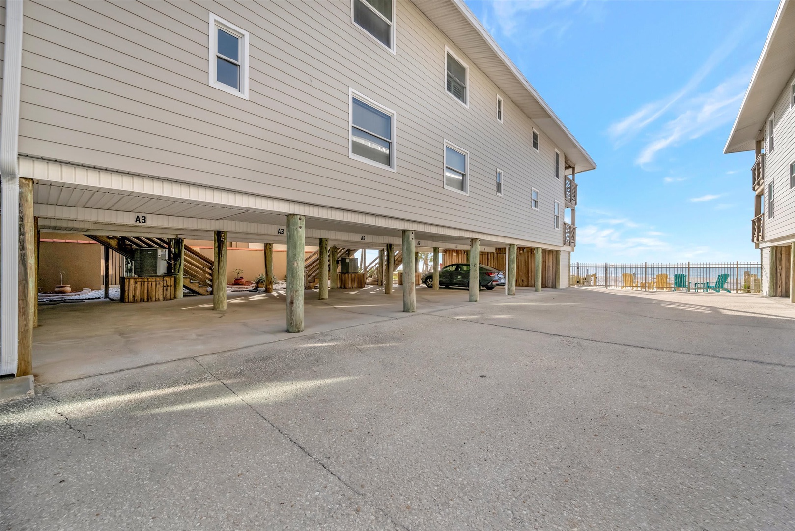 Elevated beach-style construction with covered parking beneath the building, providing convenient access and protection for your vehicles during your stay.