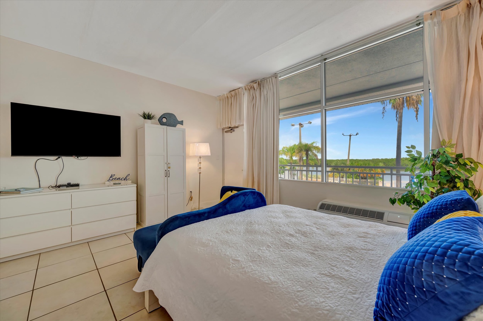 Wake up to palm trees swaying just outside your window and the promise of sunshine-filled days ahead. This cozy bedroom offers a peaceful retreat with a comfortable bed and your own private space to unwind after beach adventures.