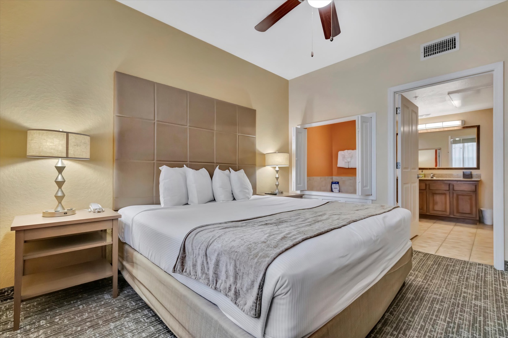 Sink into plush bedding and unwind in your private retreat, complete with vaulted ceilings, a ceiling fan, and an ensuite bathroom for ultimate convenience.