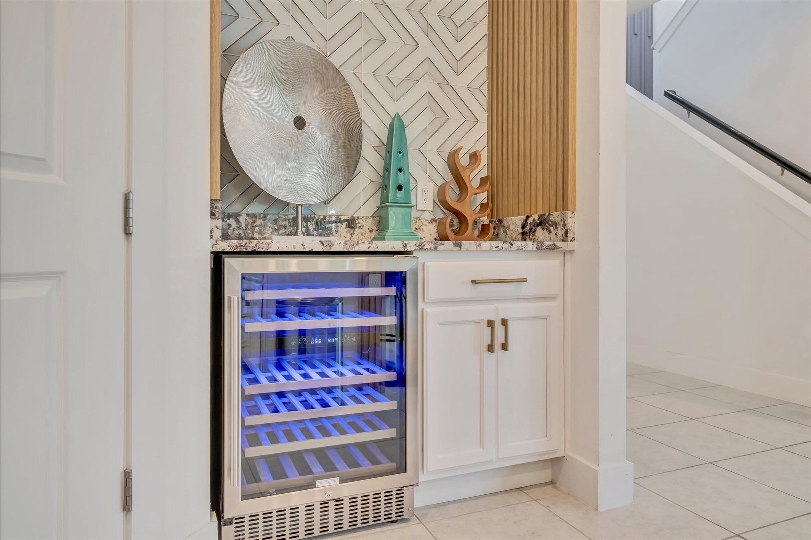 Your private wine cooler awaits, perfectly chilled and ready for relaxation. Thoughtful design meets coastal elegance in this beautifully appointed space.